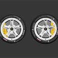 Two High Performance Tires With Silver Alloy Wheel Rims And Yellow Brake Calipers
