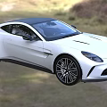 White Aston Martin Sports Car With Sleek Design On Country Grassland Road