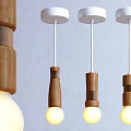 Three Modern Wooden Pendant Lights with White Base and Warm Glowing Bulbs