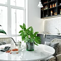 Modern Kitchen Interior With Gray Cabinets White Tile Backsplash Round Dining Table And Green Plants