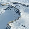 Snow Covered Great Wall With Winding Stone Path In Mountainous Winter Landscape