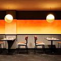 Modern Bar Interior Design With Sleek Counter Black Stools And Warm Ambient Lighting