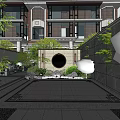 Traditional Garden Landscape With Rockery Water Feature Green Plants And Paved Courtyard