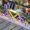 Colorful Bicycle Art Installation Photo Spot In Modern Mall With Vibrant Colors And Green Plants