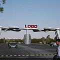 White Arched Entrance Gate With LOGO On Top Surrounded By Cars Man Trees Blue Sky