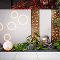 Modern Feature Wall with Illuminated Circular Lights String Lights and Moon Decoration with Green Plants and Stones