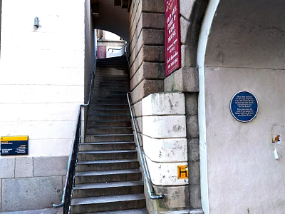 Stone Stairs With Handrail Near Archway And Red Sign Blue Plaque On Building Exterior 3d model