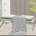 Padded Grey Ottoman Bench With Black And White Checkered Blanket And Metal Legs