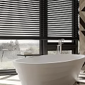 Modern Contemporary Bathroom Interior With Freestanding Bathtub Toilet And Geometric Floor Blinds