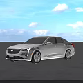 Silver Cadillac Sedan Parked On Open Ground With Blue Sky And White Clouds