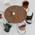 Round Wooden Dining Table Set With Assorted Color Chairs And Decorative Vase Plants
