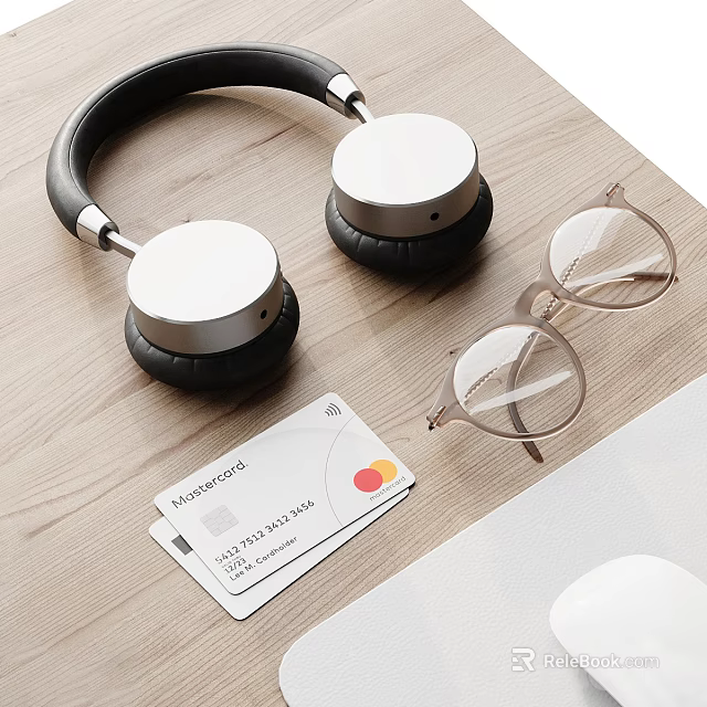 Modern Wireless Headphones With Silver Cups Leather Headband And Glasses On Wooden Desk 3d model 