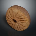 Ancient Stone Artifact With Circular Shape And Central Hole And Radiating Grooves On Dark Background
