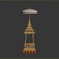 Traditional Golden Architectural Structure With White Umbrella Top Red Base And Intricate Decorative Details