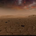 Dry Cracked Land Scenery With Red Orange Clouds And Distant Mountains At Sunset