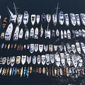 Many Different Types of Ships and Boats Arranged on Calm Water Surface