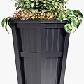 Stylish Black Garden Planter With Lush Green Plants And Orange Flowers
