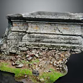 Ancient Stone Historical Ruins With Weathered Brick Layers Stones And Grass At Base
