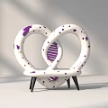 Heart Shaped Public Chair With White Body Purple Spots Intertwined Loops And Black Legs