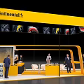 Continental Exhibition Booth With Yellow Canopy Tire Patterns People Tables Chairs And TV Screen