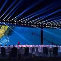 Elegant Banquet Hall With Stage Lighting White Tables And Floral Decor