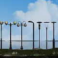 Outdoor Park Lights Various Styles Brightly Illuminated In Garden With Grass Water And Sky