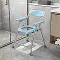 Blue Folding Toilet Chair In Bathroom With Non Slip Mat And Wooden Cabinet