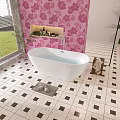 White Bathtub in Bathroom With Pink Floral Wallpaper and Black White Checkered Floor Tiles