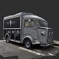 Vintage Gray Food Truck With Delicious Sign And Classic Design Parked On Street