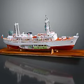 Exquisite Ship Model With Red Hull Displayed On Wooden Base 3d model