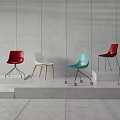Colorful Modern Dining Chairs With Metal And Wooden Legs On Step Display Against Grey Wall