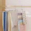 Gold Multi Hook Hanger Hanging Colorful Towels And Fabrics On Light Wall With Wooden Details