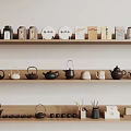 Assorted Tea Utensils Display on Wooden Shelf with Teapots Teacups and Canisters