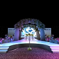 Elegant Banquet Hall Setup With Staged Platform Floral Decorations And Ambient Lighting