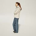 Woman In Light Jacket And Blue Pants Standing With Crossed Arms