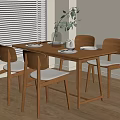 Modern Wooden Dining Table Set With Four Chairs Cushions Vase Green Plants And Wooden Floor