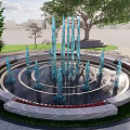 Beautiful Circular Fountain With Blue Water Jets Surrounded By Grass Trees And Flower Beds