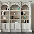 Ornate White Decorative Cabinet with Carved Classical Design Shelves Holding Books Vases and Decorative Items