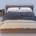 Double Bed with Brown Headboard White Pillows Gray Beige Blankets and Side Nightstand Table Lamp
