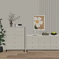 White Dressers With Multiple Drawers In Room With Green Plant Decorative Painting And Wooden Floor