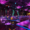 Stylish Bar Interior With Neon Lights Purple Lighting Comfortable Sofa Seats And Bar Counter