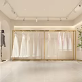 Modern Clothing Store Interior With White Dresses Gold Hangers And Green Plants