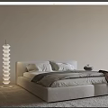 Modern Neutral Tones Double Bed With Spiral Floor Lamp And Soft Pillows On Beige Rug