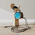 Wooden Stand Holding Black Headphones and Blue Speaker with Cables on Wooden Floor White Wall