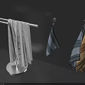White Towel On Standing Rack And Striped Towels Hanging On Wall Hooks