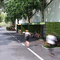Green Urban Parking Lot With Hedge Walls Bicycle Parking Trees And Pedestrians In Street Setting