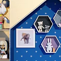 Stuffed Dolls Display With Blue Starry Background And Hexagon Display Frames On Shelves