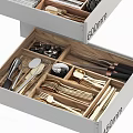 Cutlery Set Organized in Drawer with Wooden Dividers and Stainless Steel Utensils