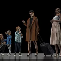 Group of Multiethnic People Including Adults and Children with Travel Luggage Standing Against Black Background