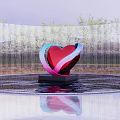 Heart Shaped Metal Sculpture With Red Pink Blue Curves In Water Pool And Metal Fence